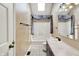 Bathroom with a shower/tub combo and vanity with decorative lighting at 8331 Tequista Ct, Indianapolis, IN 46236