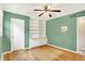 Inviting bedroom with hardwood floors, built-in shelves, and a ceiling fan at 8331 Tequista Ct, Indianapolis, IN 46236