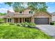 Charming two-story home with a brick and siding exterior, well-manicured lawn, and an attached two-car garage at 8331 Tequista Ct, Indianapolis, IN 46236