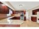 Spacious kitchen featuring stainless steel appliances, wood cabinetry, and granite countertops at 8331 Tequista Ct, Indianapolis, IN 46236