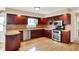 Well-equipped kitchen featuring dark wood cabinetry, granite countertops, and stainless steel appliances at 8331 Tequista Ct, Indianapolis, IN 46236