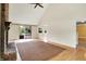 Spacious living room with fireplace, vaulted ceiling, hardwood floors and sliding glass doors at 8331 Tequista Ct, Indianapolis, IN 46236