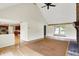 Open concept living room showing fireplace, hardwood floors and flow into the kitchen at 8331 Tequista Ct, Indianapolis, IN 46236