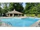 Community pool area with ample seating, a covered pavilion, and well-maintained landscaping at 8331 Tequista Ct, Indianapolis, IN 46236