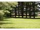 Backyard with lush green grass and mature trees providing privacy and a tranquil setting at 8373 W State Road 47, Thorntown, IN 46071