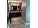 Bathroom with wood look floor, double sinks, and large mirror at 8373 W State Road 47, Thorntown, IN 46071