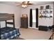 Bright bedroom with neutral walls, ceiling fan, plush carpet, bunk beds, and ample shelf space at 8373 W State Road 47, Thorntown, IN 46071