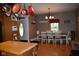 Charming dining room with wood floors, modern chandelier, and a view into another room at 8373 W State Road 47, Thorntown, IN 46071