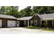Charming home featuring a brown exterior, attached garage, and a landscaped front yard with gravel driveway at 8373 W State Road 47, Thorntown, IN 46071