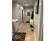 Hallway featuring a laundry room, bench and access to the exterior at 8373 W State Road 47, Thorntown, IN 46071