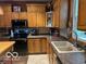 Traditional kitchen with black appliances and oak cabinets at 8373 W State Road 47, Thorntown, IN 46071