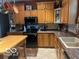 Traditional kitchen with black appliances and oak cabinets at 8373 W State Road 47, Thorntown, IN 46071