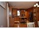 Open kitchen with wood cabinets, stainless steel appliances, island with seating and track lighting at 8373 W State Road 47, Thorntown, IN 46071