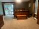 Cozy main bedroom featuring a wooden sleigh bed, neutral carpet and sliding glass door to the backyard at 8373 W State Road 47, Thorntown, IN 46071