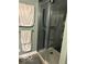 Shower featuring glass door, gray tile, shower caddy, and shower head at 8373 W State Road 47, Thorntown, IN 46071