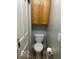 View of a compact toilet and a wooden cabinet at 8373 W State Road 47, Thorntown, IN 46071