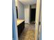Bathroom with vanity and closet area featuring neutral color palette and tile flooring at 842 Westpointe Dr, Shelbyville, IN 46176