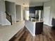 Bright kitchen with dark cabinetry, granite countertops, stainless appliances and an island at 842 Westpointe Dr, Shelbyville, IN 46176