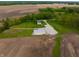 Aerial view of a quaint home with a detached garage surrounded by farmland and trees at 8468 S County Road 575 E, Mooresville, IN 46158