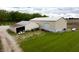 Aerial view showcases the building's exterior with its metal roof and surrounding lush green lawn at 8468 S County Road 575 E, Mooresville, IN 46158