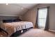 Comfortable bedroom with a large bed, neutral tones, and natural light from the window at 8468 S County Road 575 E, Mooresville, IN 46158