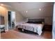 Cozy bedroom features neutral tones, a large bed and an attached ensuite bathroom at 8468 S County Road 575 E, Mooresville, IN 46158