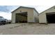 The tan building has a large garage door, gravel parking area and lawn with equipment stored near by at 8468 S County Road 575 E, Mooresville, IN 46158
