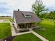 Charming home featuring a cozy front porch with stone accents and a meticulously maintained lawn at 8468 S County Road 575 E, Mooresville, IN 46158