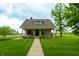 Inviting home with a manicured lawn, cozy porch and charming front facade at 8468 S County Road 575 E, Mooresville, IN 46158