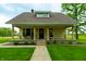 Beautiful home with a welcoming front porch, stone accents, and lush greenery at 8468 S County Road 575 E, Mooresville, IN 46158