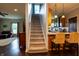 Bright open interior view of kitchen and staircase featuring bar seating and a modern kitchen design at 8468 S County Road 575 E, Mooresville, IN 46158