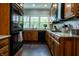Traditional kitchen with granite countertops, black appliances and a large window letting in natural light at 8468 S County Road 575 E, Mooresville, IN 46158