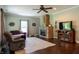 Cozy living room with a brick fireplace, ceiling fan and comfortable seating arrangement at 8468 S County Road 575 E, Mooresville, IN 46158