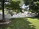 Green backyard with a white fence and a shed, perfect for outdoor activities and storage at 912 Delray Dr, Indianapolis, IN 46241
