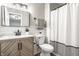 Modern bathroom featuring new vanity, toilet, mirror, and shower with decorative curtain at 912 Delray Dr, Indianapolis, IN 46241