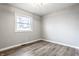 Bedroom featuring neutral walls, new flooring, and a window with natural light at 912 Delray Dr, Indianapolis, IN 46241