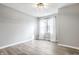 Bright bedroom featuring neutral walls, new flooring, and a large window at 912 Delray Dr, Indianapolis, IN 46241