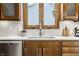 Bright kitchen features wood cabinets, white countertops, tile backsplash, and stainless steel dishwasher at 912 Delray Dr, Indianapolis, IN 46241