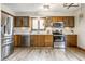 Well-equipped kitchen featuring stainless steel appliances, wooden cabinetry, and ample counter space at 912 Delray Dr, Indianapolis, IN 46241