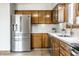 Bright kitchen showcasing wooden cabinets, stainless steel refrigerator, and modern finishes at 912 Delray Dr, Indianapolis, IN 46241