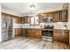 Updated kitchen featuring stainless steel appliances and wooden cabinetry at 912 Delray Dr, Indianapolis, IN 46241