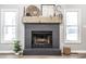 Cozy living room with a striking brick fireplace and decorative mantle at 912 Delray Dr, Indianapolis, IN 46241