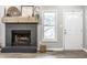 Inviting living room with a stylish brick fireplace and new laminate flooring at 912 Delray Dr, Indianapolis, IN 46241