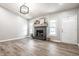 Open-concept living area with a modern fireplace, bright windows, and laminate flooring at 912 Delray Dr, Indianapolis, IN 46241
