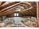 Unfinished attic space showing exposed rafters, beams, and insulation, offering potential for customization at 920 E Tabor St, Indianapolis, IN 46203