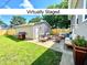 Virtually staged backyard featuring a patio with outdoor furniture, a grill, and a well-manicured lawn at 920 E Tabor St, Indianapolis, IN 46203