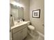 Cozy bathroom showcases a gray vanity, framed mirror, and convenient towel rack at 920 E Tabor St, Indianapolis, IN 46203