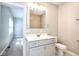 Bathroom featuring a sink with gray cabinets, a large mirror, and a view into a bedroom at 920 E Tabor St, Indianapolis, IN 46203