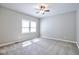 Spacious bedroom featuring neutral carpet, a ceiling fan, and a large window for natural light at 920 E Tabor St, Indianapolis, IN 46203