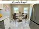 Cozy dining area with modern furniture and stainless steel appliances in a staged setting at 920 E Tabor St, Indianapolis, IN 46203